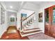 Bright entryway with hardwood floors and wooden staircase at 26 Cormorant Island Ln, Kiawah Island, SC 29455