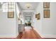 Bright hallway with hardwood floors, decorative console table and artwork at 26 Cormorant Island Ln, Kiawah Island, SC 29455