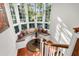 Sunlit landing features a built-in window seat with pillows, a small table, and hardwood floors at 26 Cormorant Island Ln, Kiawah Island, SC 29455