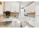 Laundry room with white cabinets, sink, and patterned wallpaper at 26 Cormorant Island Ln, Kiawah Island, SC 29455