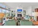 Open living room featuring a fireplace, large windows, and water views at 26 Cormorant Island Ln, Kiawah Island, SC 29455