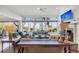Spacious living room boasts stunning water views and a cozy fireplace at 26 Cormorant Island Ln, Kiawah Island, SC 29455