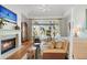 Main bedroom with fireplace, sitting area, and large windows offering water views at 26 Cormorant Island Ln, Kiawah Island, SC 29455