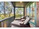 Spacious screened porch with lounge chairs and marsh views at 26 Cormorant Island Ln, Kiawah Island, SC 29455