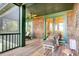 Relaxing screened porch with wooden floors and comfy seating at 26 Cormorant Island Ln, Kiawah Island, SC 29455