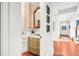 Charming powder room with antique vanity and striped wallpaper at 26 Cormorant Island Ln, Kiawah Island, SC 29455