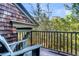 Private balcony with wooden chair and tranquil wooded views at 26 Cormorant Island Ln, Kiawah Island, SC 29455