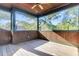 Relaxing screened porch with wood floors and views of lush trees at 26 Cormorant Island Ln, Kiawah Island, SC 29455