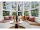 Charming sitting area boasts a curved window seat, hardwood floors, and decorative pillows at 26 Cormorant Island Ln, Kiawah Island, SC 29455