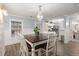 Bright dining area with a farmhouse table and view into the kitchen at 3043 Mapleleaf Dr., Moncks Corner, SC 29461
