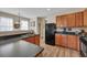 Modern kitchen with wood cabinets, black appliances, and a spacious layout at 329 Flyway Rd, Goose Creek, SC 29445
