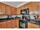 Modern kitchen with black appliances and wood cabinets at 329 Flyway Rd, Goose Creek, SC 29445