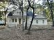 White two-story farmhouse nestled among lush trees at 3315 Hopkinson Plantation Rd, Johns Island, SC 29455