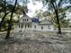 White farmhouse exterior with wraparound porch and mature trees at 3315 Hopkinson Plantation Rd, Johns Island, SC 29455