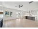 Open concept kitchen with island, white cabinets, and hardwood floors at 3315 Hopkinson Plantation Rd, Johns Island, SC 29455