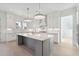 Modern kitchen with white cabinets, large island, and quartz countertops at 3315 Hopkinson Plantation Rd, Johns Island, SC 29455