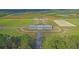Wide shot of the entire property, showing the barn, arenas, and surrounding land at 4007 Capensis Ln, Ravenel, SC 29470