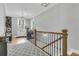 Upstairs hallway with wood flooring, a patterned rug, and a view of the staircase at 4007 Capensis Ln, Ravenel, SC 29470