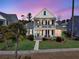 Two-story house with front porch, lit at dusk at 4007 Capensis Ln, Ravenel, SC 29470
