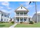 Two-story house with front porch and landscaping at 4007 Capensis Ln, Ravenel, SC 29470