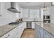 Modern kitchen with white cabinets, granite countertops, and stainless steel appliances at 4007 Capensis Ln, Ravenel, SC 29470