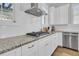 White kitchen cabinets, granite countertops and gas cooktop at 4007 Capensis Ln, Ravenel, SC 29470