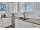White kitchen with granite countertops and stainless steel dishwasher at 4007 Capensis Ln, Ravenel, SC 29470