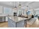 Open concept kitchen features granite countertops, stainless steel appliances, and an island at 4007 Capensis Ln, Ravenel, SC 29470