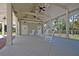 Covered patio with rocking chairs overlooking the pool at 4007 Capensis Ln, Ravenel, SC 29470