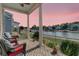 Relaxing covered porch overlooking a serene lake at 4007 Capensis Ln, Ravenel, SC 29470