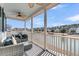 Porch with wicker furniture and ceiling fan overlooking a lake at 4007 Capensis Ln, Ravenel, SC 29470