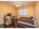 Bedroom with hardwood floors, a bed, and a workspace at 411 Constance St, Walterboro, SC 29488