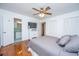 Bedroom with hardwood floors, gray bedding, and en-suite bathroom at 411 Constance St, Walterboro, SC 29488