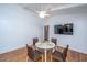 Bright dining area with white table and four brown chairs, hardwood floors at 411 Constance St, Walterboro, SC 29488
