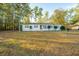 White brick ranch house with large yard and mature trees at 411 Constance St, Walterboro, SC 29488