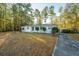 White brick ranch house with driveway and storage shed at 411 Constance St, Walterboro, SC 29488