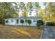 White brick ranch house with a spacious yard and trees at 411 Constance St, Walterboro, SC 29488