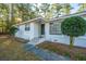 White brick ranch house with updated front entrance and landscaping at 411 Constance St, Walterboro, SC 29488