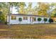 Beautiful home with a classic white exterior, complemented by well-kept landscaping and a lush green lawn at 411 Constance St, Walterboro, SC 29488