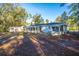 Back of house with screened porch, storage shed, and large yard at 411 Constance St, Walterboro, SC 29488