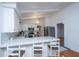 Modern kitchen with white cabinets, marble countertops, and stainless steel appliances at 411 Constance St, Walterboro, SC 29488