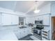 Modern kitchen with white cabinets, marble countertops, and stainless steel appliances at 411 Constance St, Walterboro, SC 29488