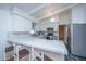 Modern kitchen with white cabinets, marble countertops, and stainless steel appliances at 411 Constance St, Walterboro, SC 29488