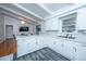 Modern kitchen with white cabinets, marble countertops, and stainless steel appliances at 411 Constance St, Walterboro, SC 29488