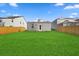 Spacious backyard with a large grassy area and wooden privacy fence at 415 Broad Elm Way, Summerville, SC 29486