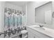Clean bathroom with white vanity, a shower/tub combo, and a decorative shower curtain at 415 Broad Elm Way, Summerville, SC 29486