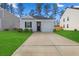 Charming one-story home with a gray exterior, landscaped lawn, and a two-car garage at 415 Broad Elm Way, Summerville, SC 29486