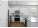 Modern kitchen with white cabinets, granite countertops, and stainless steel appliances at 415 Broad Elm Way, Summerville, SC 29486