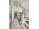 Bright and spacious entryway with hardwood floors, a statement light fixture, and a staircase at 457 Eagleview Dr, Moncks Corner, SC 29461