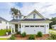 Charming white farmhouse with a two-car garage and well-manicured landscaping at 457 Eagleview Dr, Moncks Corner, SC 29461
